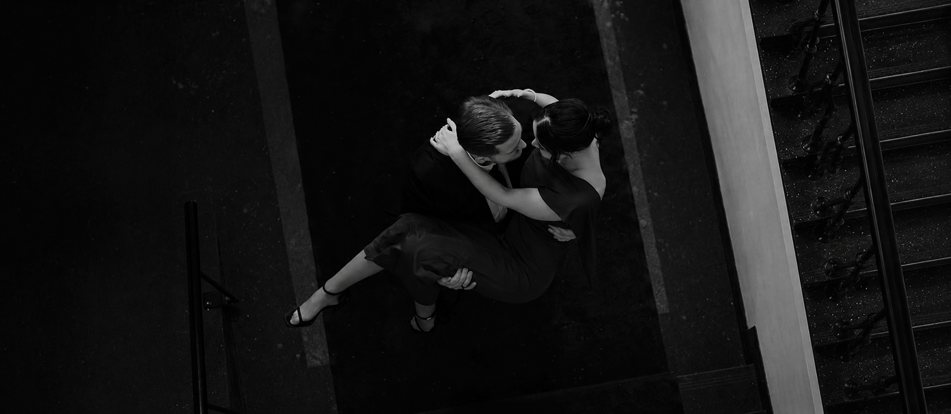 Katrin and Andreas seen from above on a dark staircase